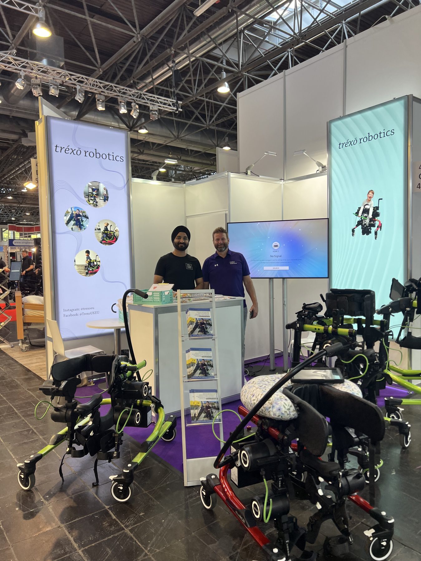 The Trexo team with walking devices at an exhibition booth
